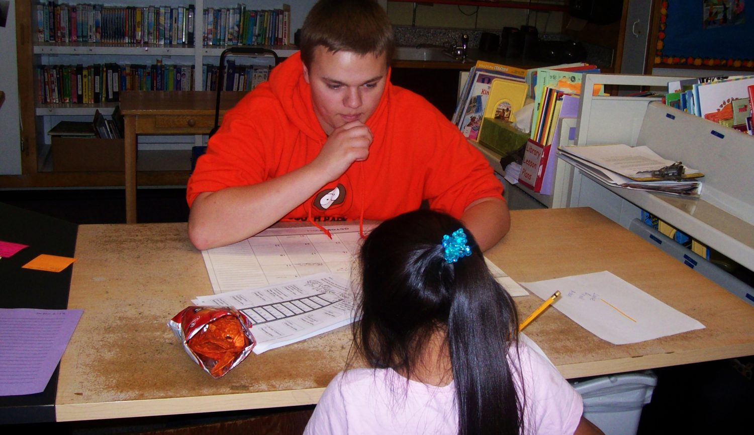 Luke Pickett (18) helping an EES student with her homework. 