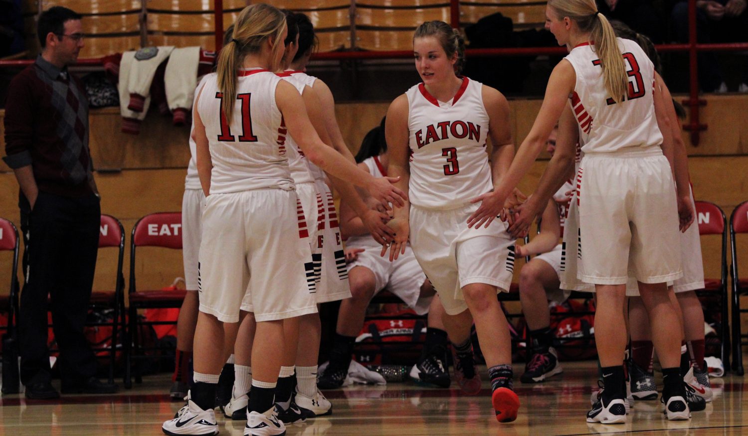 Bailey Jones high fives her teammates as a starter in the game. 
