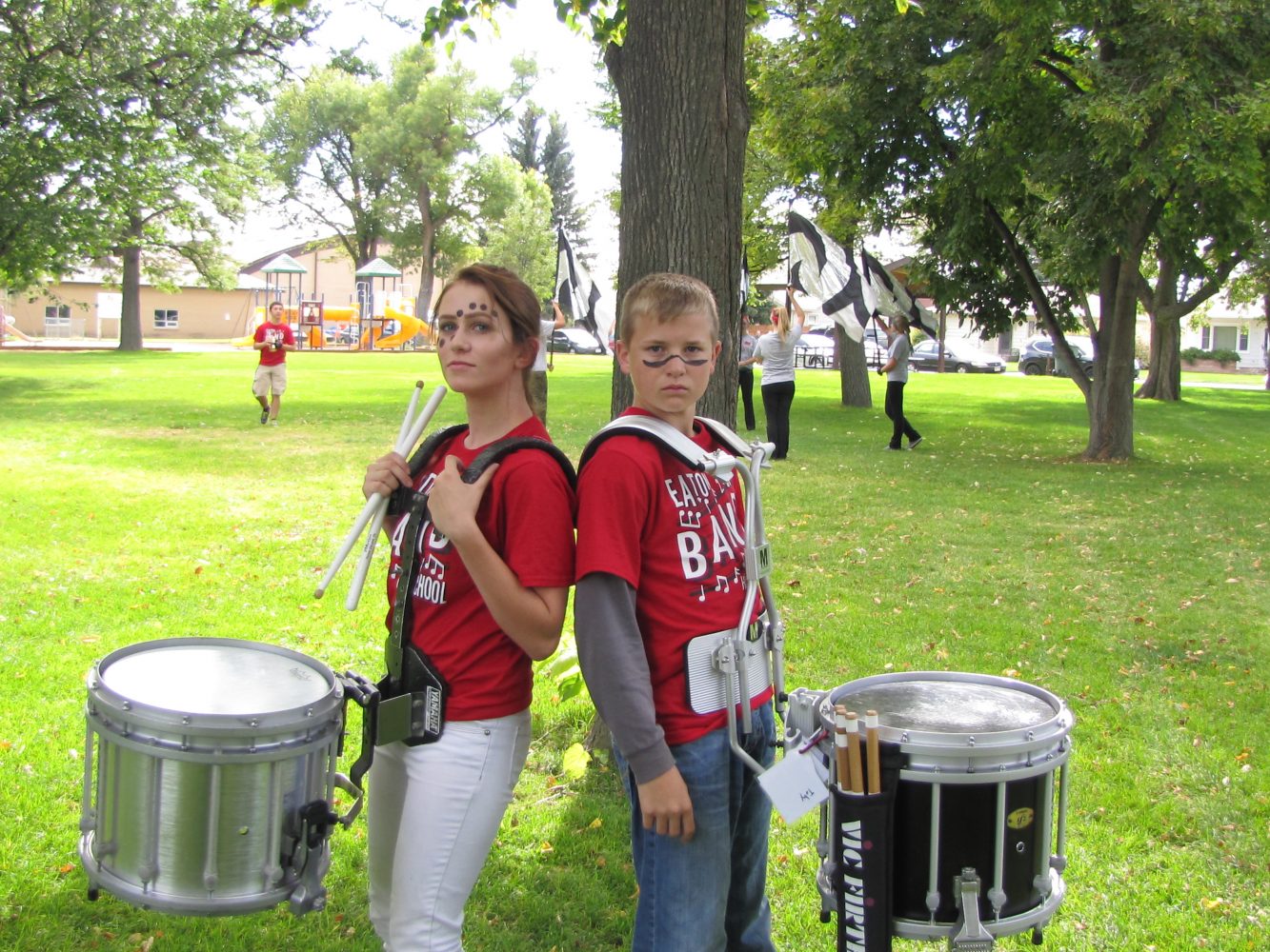 Drum players, Shelby Dyer (19) and Toby Gavette (19), pose for an image before their performance in the parade.