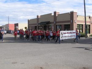 Eaton Marching Band marches their way through the streets playing their instruments for the crowds entertainment.