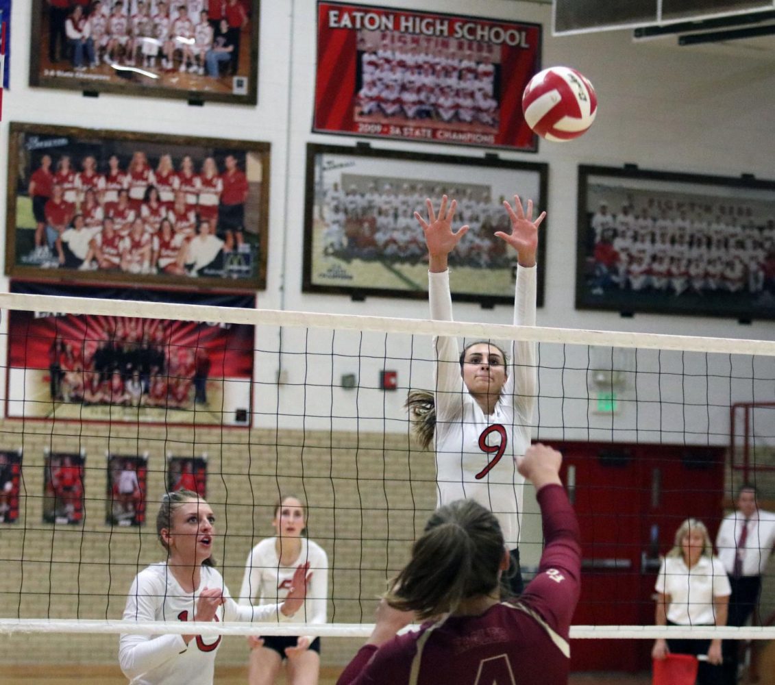 Alexis Lamoreaux (18) goes up for a solo block on an outside attack.
