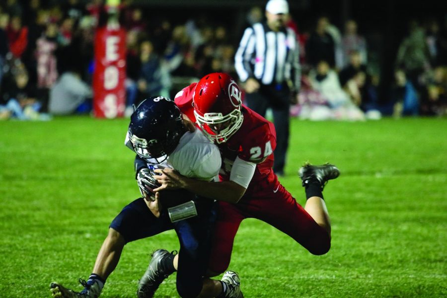 Fullback Jesse Mongan makes an open field tackle against a Timberwolf player. Mongan had two tackles

on the evening helping the Reds defense completely disable Pinnacle’s