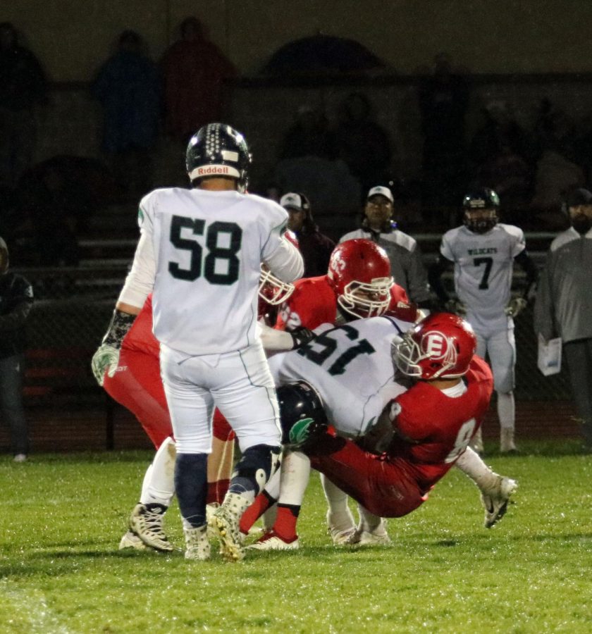 Seniors Ty Garnhart (19) and Danny Chavez (19) tackle a player from The Academy