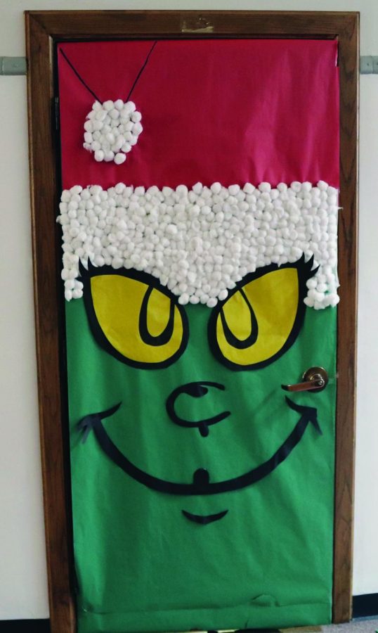 Teacher Brittany Turnbull’s door screams Christmas with a Grinch portrait made of butcher paper and cotton balls.