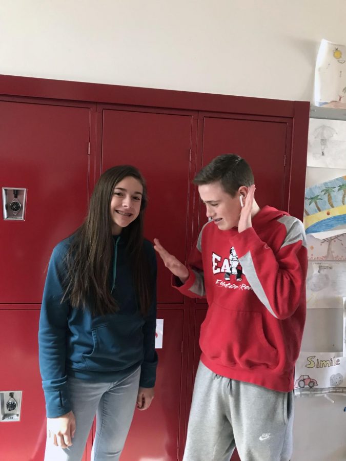 Liam Wray (22) shows off his new AirPods to Taylor Bradshaw (22).