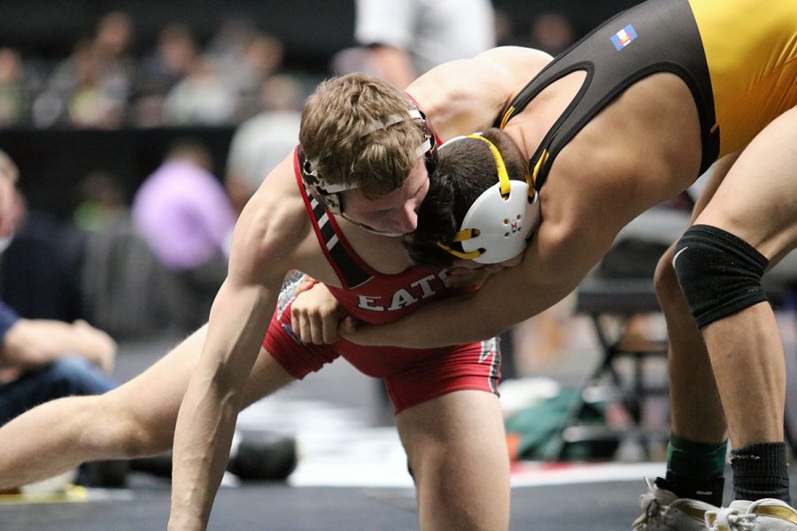 Senior Dylan Yancey attempts to score points by making a move on his opponent in the class 3A 138 pound finals match. Yancey ended up finishing 2nd place at state. For more wrestling photos see the Red Ink Wrestling gallery: https://eatonredink.com/10386/uncategorized/wrestling-2019/