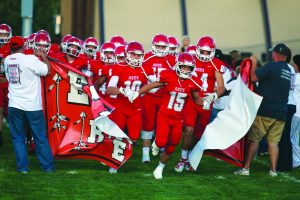 The Reds break through the banner as they run onto the field for their home game against DEvelyn.