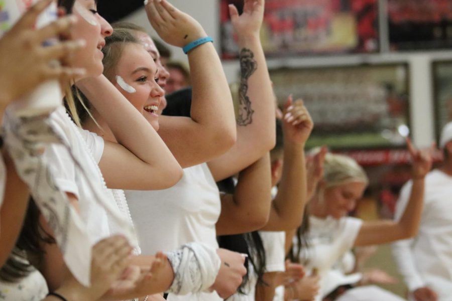 Student section dresses in White Out attire to show support for Reds Volleyball