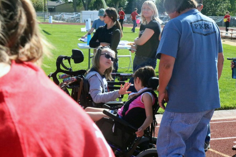Two participants in wheelchairs are showing sportsmanship