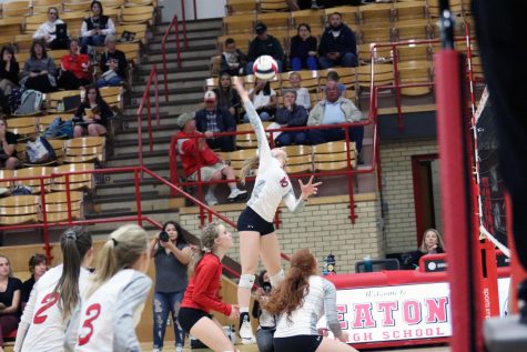 Sydney Leffler (21) jumps and hits the ball for the kill. 