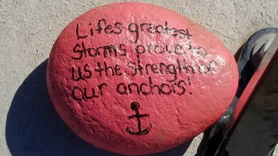 A painted rock placed under a bench at Windsor Lake in Windsor Colorado