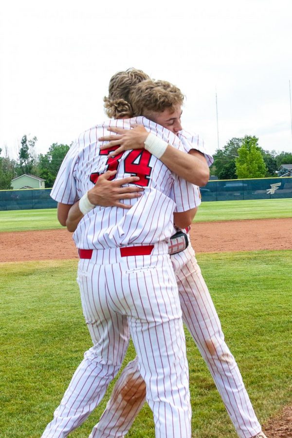 Tate Smith (23) and Walker Martin (23) embrace and share a moment after winning the State Championship. 