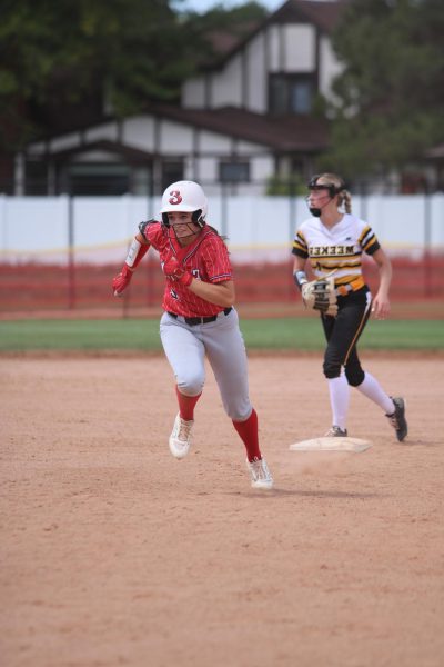 Emma Anderson(27) sprints towards third base during the game against Meeker on Aug. 23 

